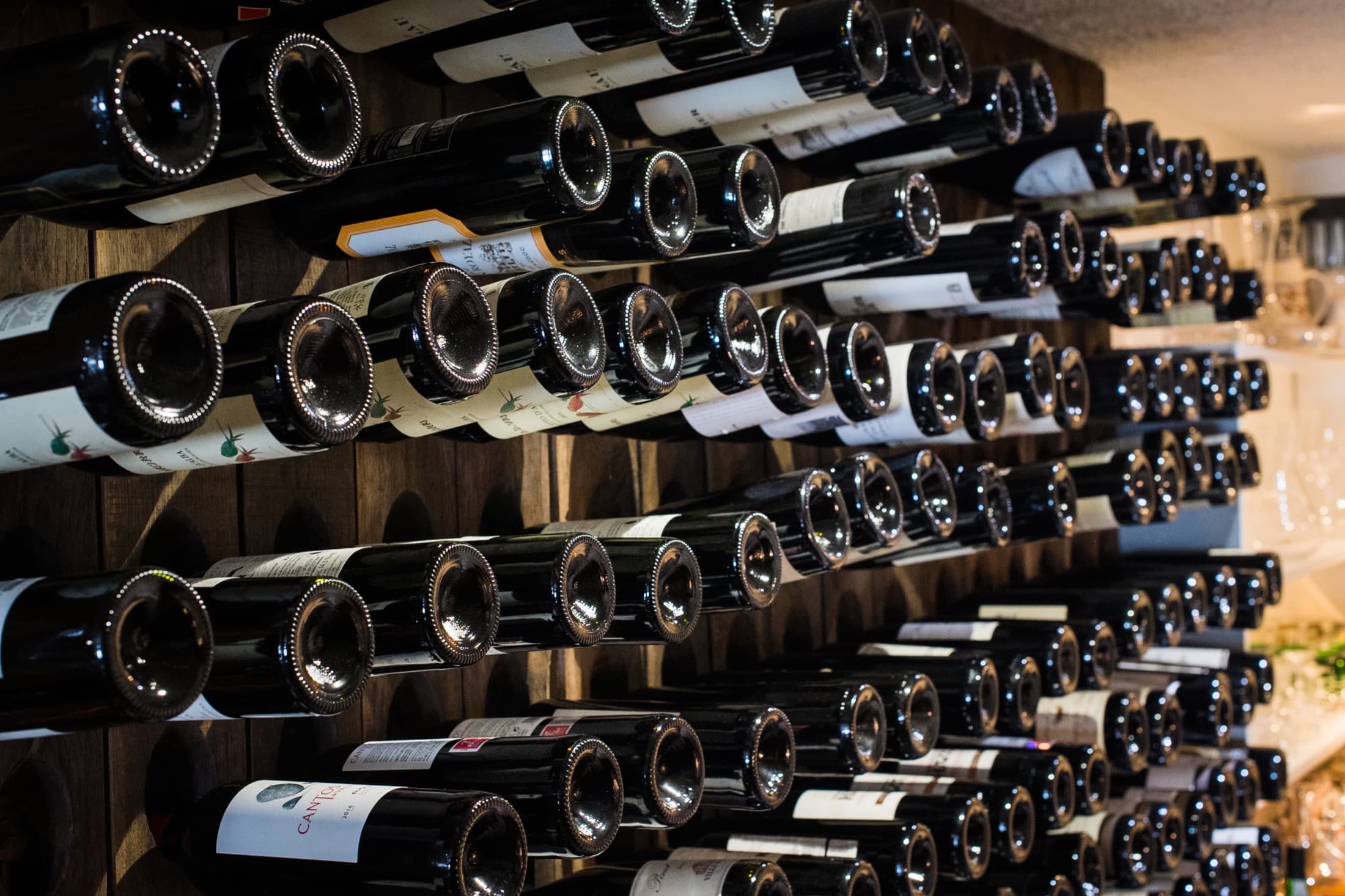 Wine bottles resting in Aherne’s traditional riddling racks